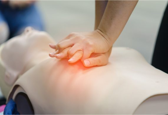 Person practicing CPR on a manikin