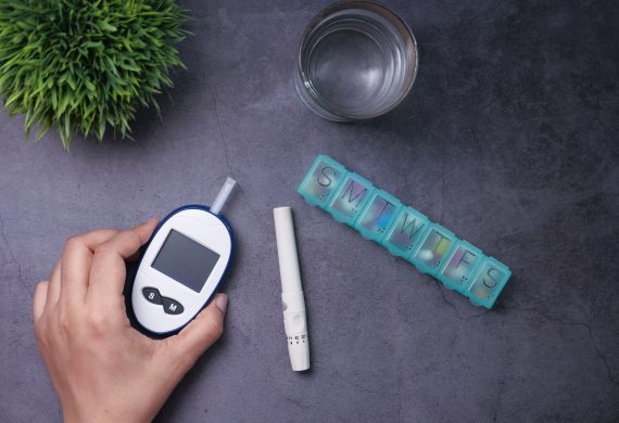 Person holding a blood glucose meter