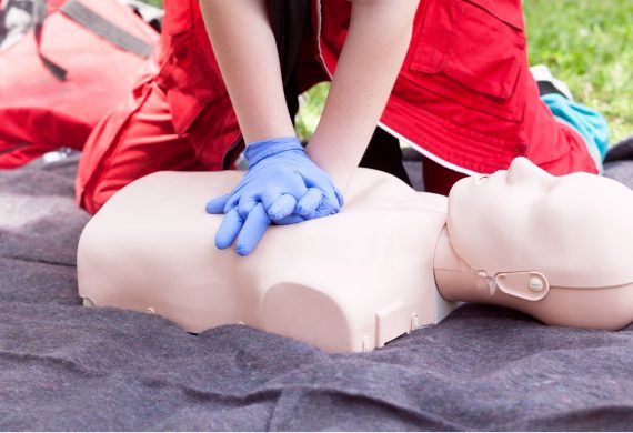 Person performing CPR on a manikin