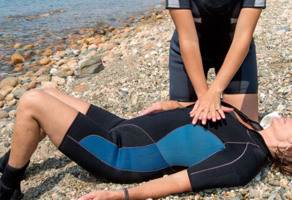 Person performing CPR on a woman