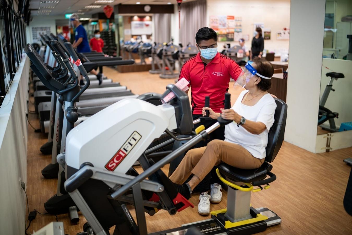 Therapy Assistant Muhamad Haziq Afiq and a client at the SHF-Philips Foundation Heart Wellness Centre