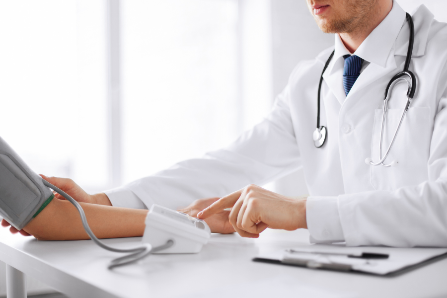 A doctor using a blood pressure monitor