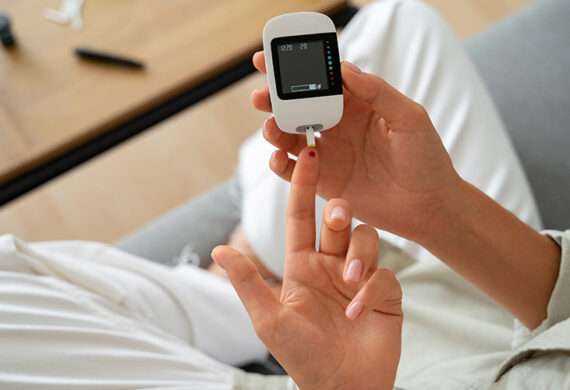 Patient using a glucose meter to monitor blood sugar levels.