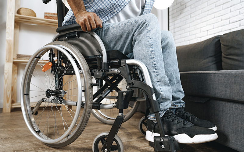 Individual in a wheelchair managing complications caused by diabetes.