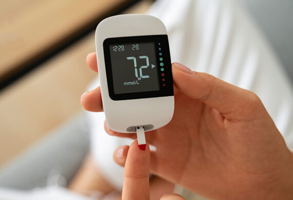 Patient using a glucose meter to monitor diabetes levels.