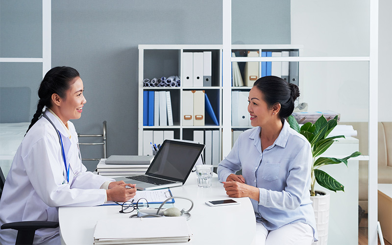 Doctor consulting patient in office setting.