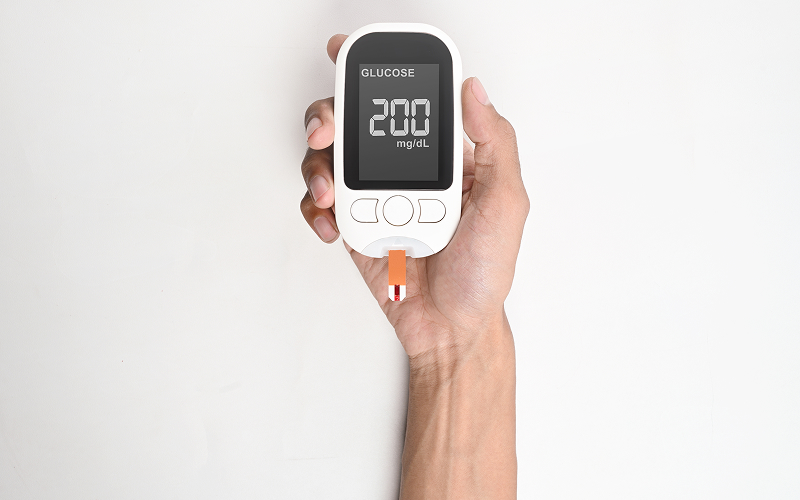 Glucose meter showing high blood sugar metabolic health link.