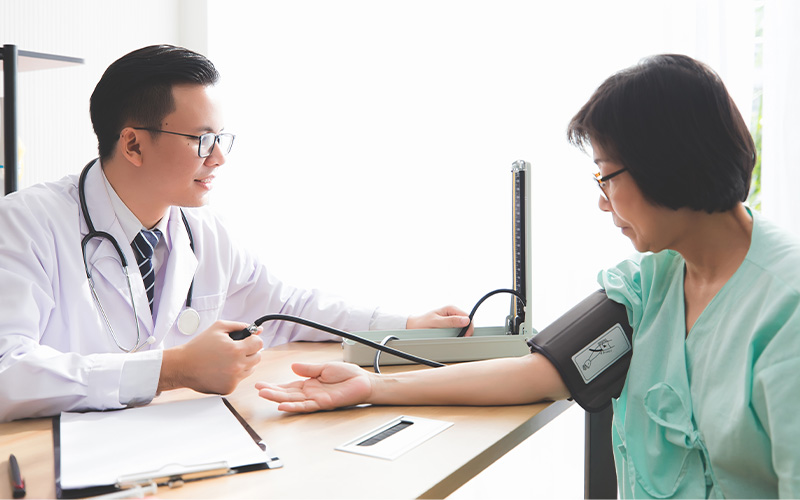 Doctor measuring patient’s blood pressure.