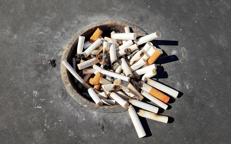 Cigarette butts in ashtray representing lifestyle heart disease risks