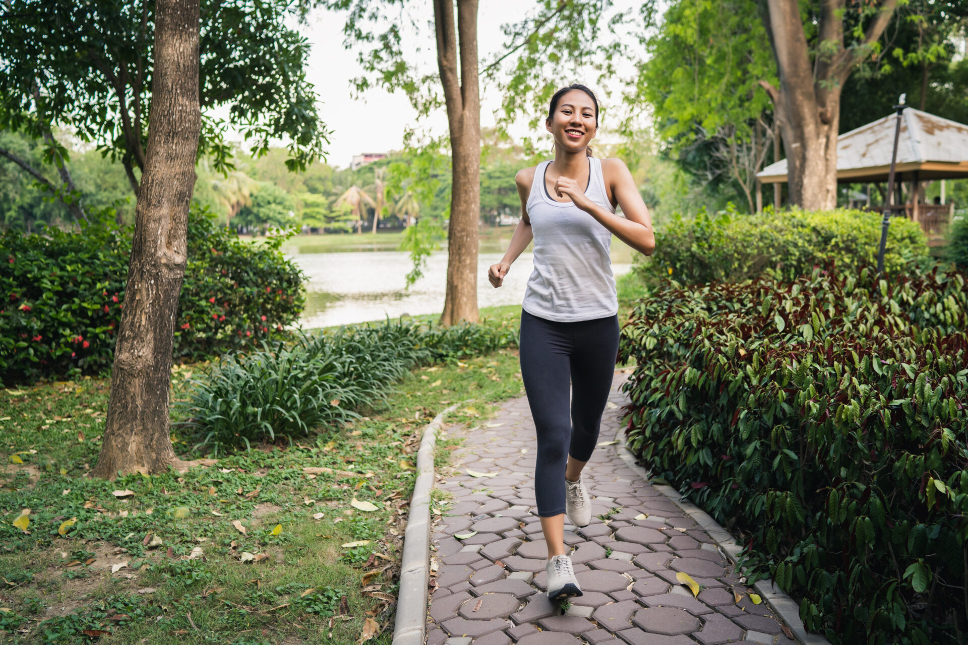 Woman walking in park adopting habits to prevent a stroke.